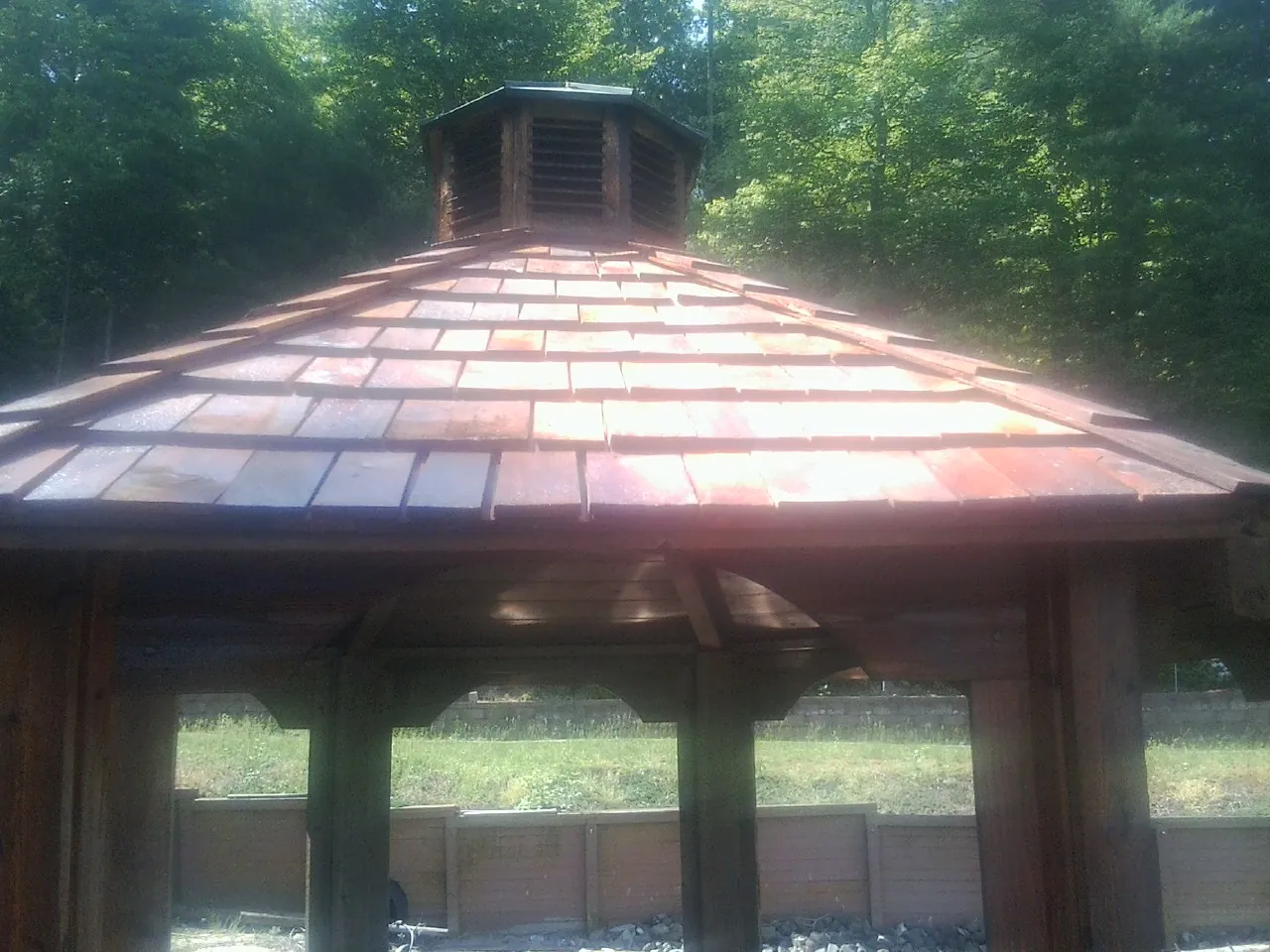 New cedar shake roof and cupola on a lakeside gazebo in Greycliff